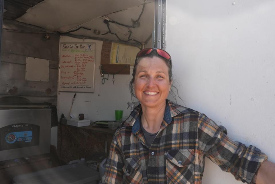 Stéphanie Vaillancourt, the operator of Fish on the Bay, stands in the door way of her trailer in Old Town. It's where she fillets and sells fish to residents. 