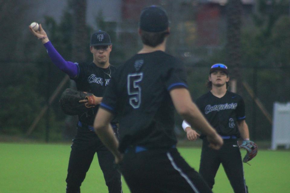 Trinity Christian first baseman Brayden Harris (9) throws to pitcher Aaron Watson (5), covering first, during Monday's win over Providence.