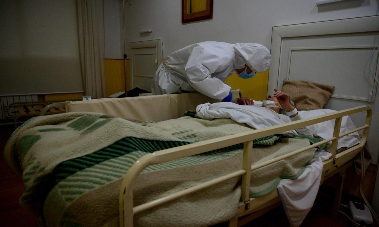 <span>A doctor attends to a woman at a care home in Pozuelo de Alarcon in the Madrid region on 15 April 2020. </span><span>Photograph: Pierre-Philippe Marcou/AFP/Getty Images</span>