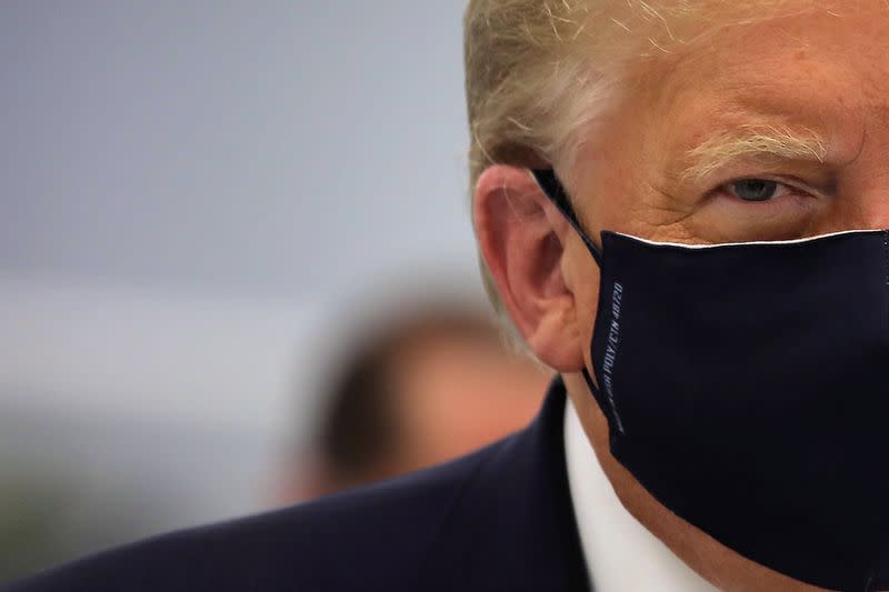 U.S. President Donald Trump wears a protective face mask during a tour of the Fujifilm Diosynth Biotechnologies' Innovation Center, in Morrisville