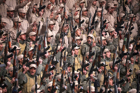 Fighters from the self-defence forces of the Kurdish-led north hold their weapons during a rally in Hasaka, northeastern Syria, January 23, 2018. REUTERS/Rodi Said