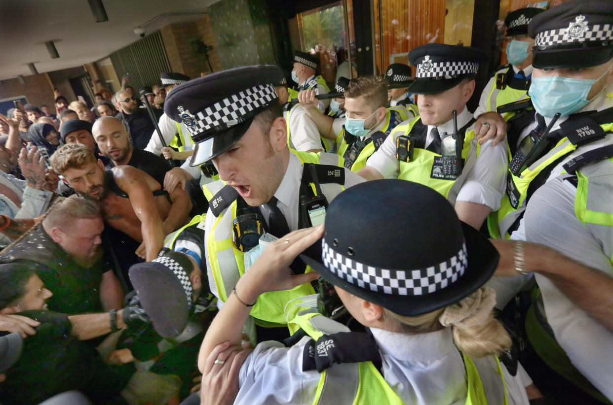 LONDON, UNITED KINGDOM - 2021/08/09: Police officers stop protesters from accessing Studioworks during the demonstration.
Protesters gathered outside Studioworks to show their dismay against the BBC media bias, covid restrictions, vaccine passports and the loss of freedom under the Coronavirus Act. They intend to block Studioworks in Wood Lane until the government listen to their concerns. (Photo by Martin Pope/SOPA Images/LightRocket via Getty Images)