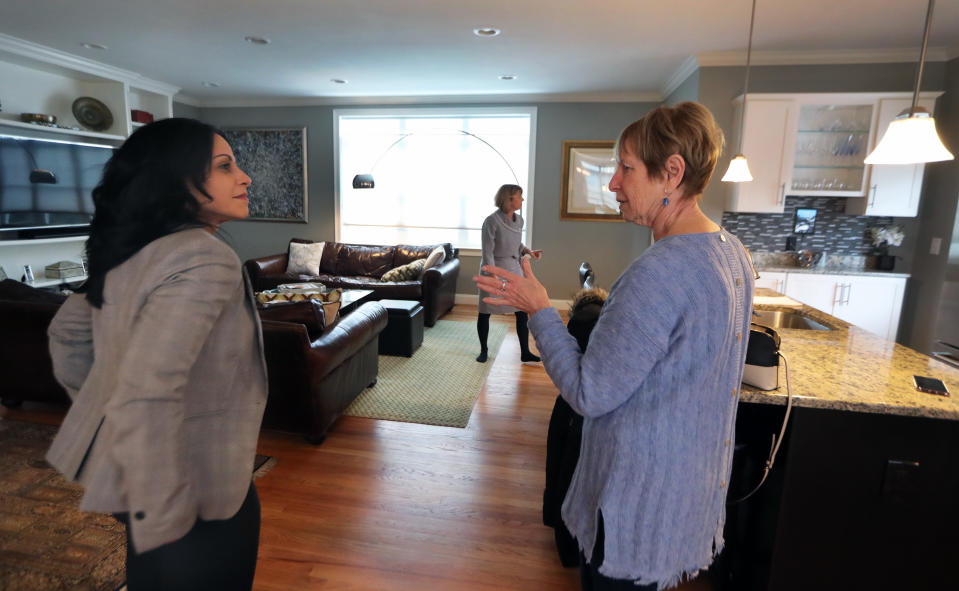 WALTHAM, MA - FEBRUARY 24: Cynthia Pill, right, talks with broker Marie Presti, background center, and real estate agent Mary Guilloty, left, at the townhouse in Waltham, MA, that her daughter is purchasing on Feb. 24, 2019. Her daughter, Karen Fiello (not pictured), is downsizing from a 5,000-square-foot home in the Syracuse, N.Y., area. Presti, Fiellos broker, said the biggest takeaway is that when it comes to downsizing, the earlier you start the process, the better. Presti is the broker/owner of The Presti Group in Newton. She began teaching a downsizing class 10 years ago, as the first wave of baby boomers entered their 60s, and is of the ethos that Its not about downsizing, its about right-sizing." (Photo by Jim Davis/The Boston Globe via Getty Images)