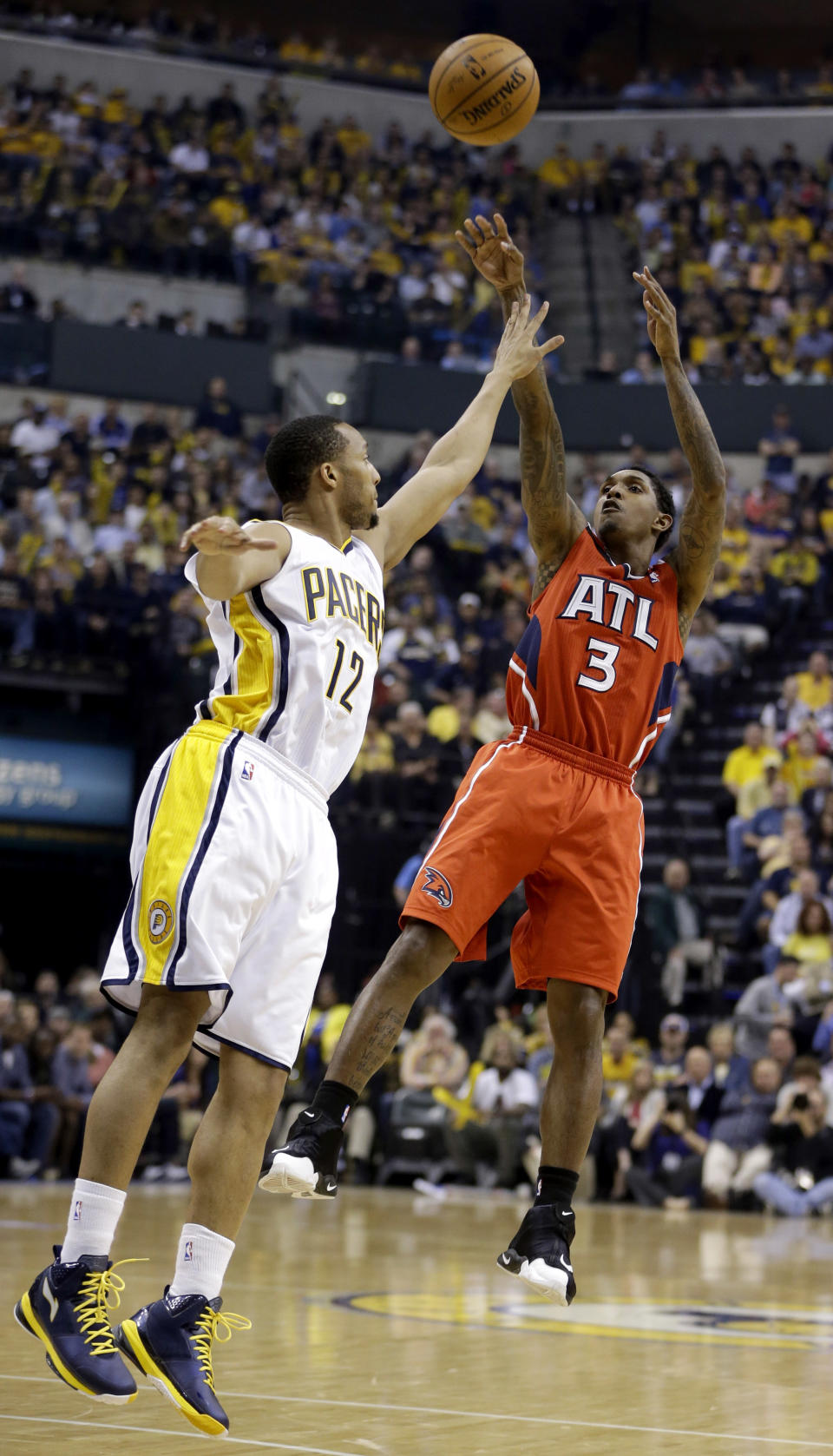 Atlanta Hawks' Louis Williams (3) shoots over Indiana Pacers' Evan Turner (12) during the first half in Game 5 of an opening-round NBA basketball playoff series Monday, April 28, 2014, in Indianapolis. (AP Photo/Darron Cummings)