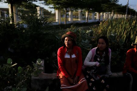 Khen Srey Touch, 27, who is nine months pregnant, waits for a pickup truck to go home after work at Complete Honour Footwear Industrial, a footwear factory owned by a Taiwan company, in Kampong Speu, Cambodia, July 4, 2018. Khen Srey Touch works 10 hours a day, six days a week and earns $240 a month. "I am the main breadwinner of the house," she said. REUTERS/Ann Wang