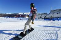 U.S. snowboarder Shaun White cruises out of the finish area during snowboard slopestyle training at the 2014 Sochi Winter Olympics in Rosa Khutor February 3, 2014. REUTERS/Mike Blake