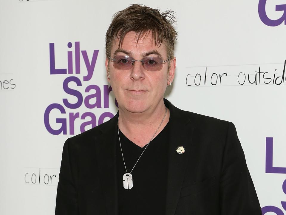 Andy Rourke in a black suit
