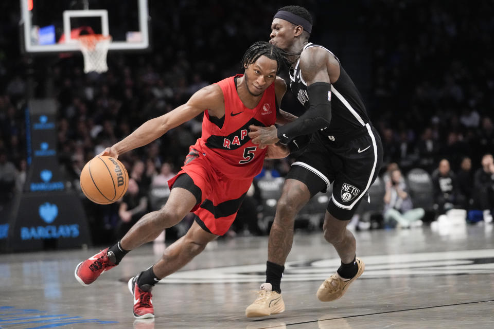 Toronto Raptors guard Immanuel Quickley (5) drives against Brooklyn Nets guard Dennis Schroder during the second half of an NBA basketball game, Wednesday, April 10, 2024, in New York. The Nets won 106-102. (AP Photo/Mary Altaffer)