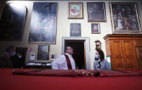 Rev. Mario Carminati talks with a woman before celebrating Mass inside the Santissima Redentore church in Seriate, near Bergamo, Italy, Sunday, Sept. 27, 2020. If there is anything the Rev. Carminati and the traumatized residents of Italy’s Bergamo province remember about the worst days of the coronavirus outbreak, it’s the wail of ambulance sirens piercing the silence of lockdown.(AP Photo/Antonio Calanni)