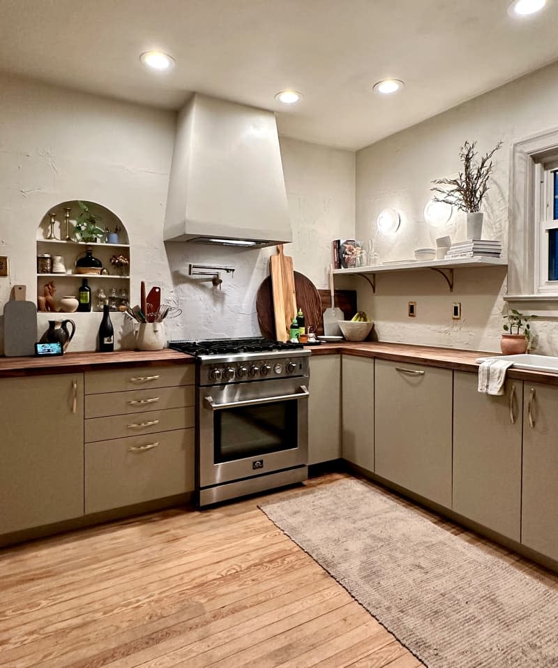 Neutral colored kitchen with open cabinets after renovation.