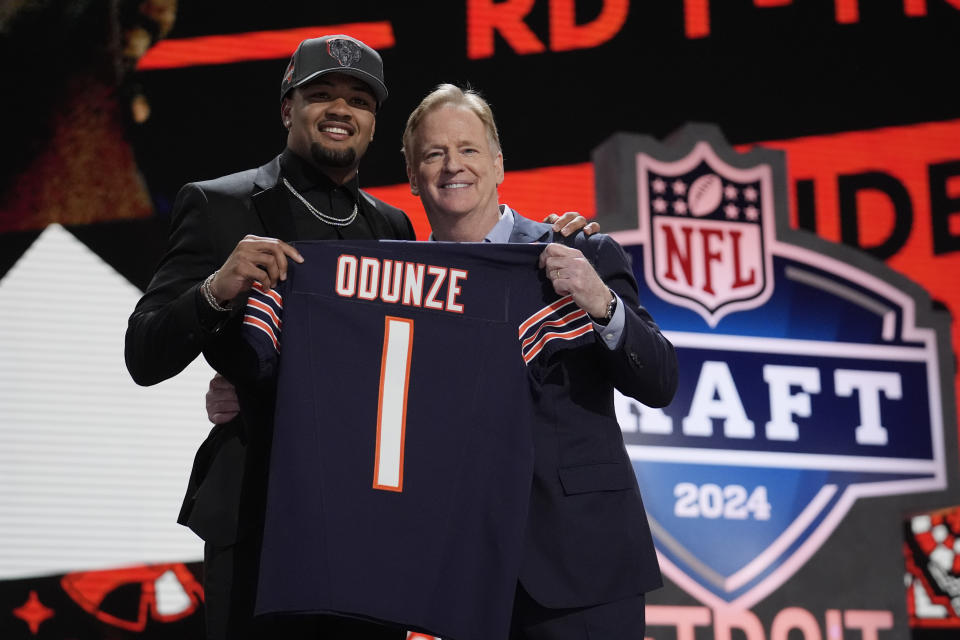 Washington wide receiver Rome Odunze, left, poses with NFL Commissioner Roger Goodell after being chosen by the Chicago Bears with the ninth overall pick during the first round of the NFL football draft, Thursday, April 25, 2024, in Detroit. (AP Photo/Jeff Roberson)