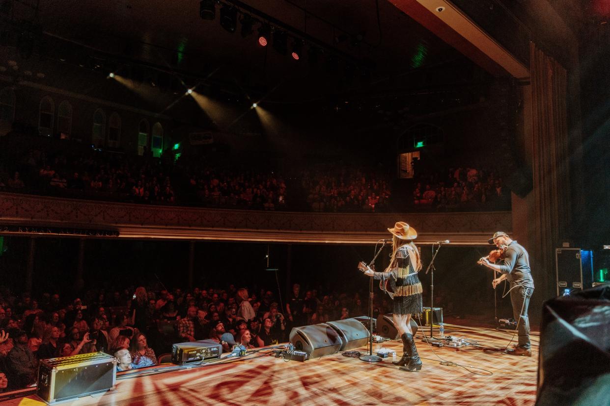 Kaitlin Butts, onstage, with fiddle player Lane Hawkins, at the Ryman Auditorium, 4/7/2023