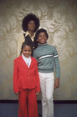 <p>Tim Boxer/Getty </p> Janet Jackson with brothers Michael and Randy in 1974