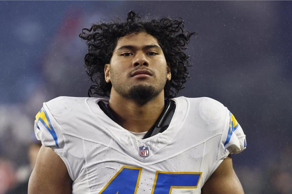 Chargers linebacker Tuli Tuipulotu walks off the field after a game against the Patriots.