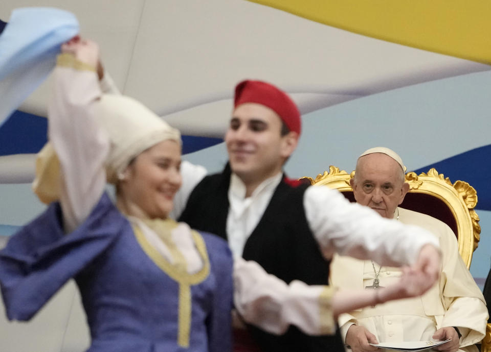 Pope Francis meets young people at the Saint Dionysius School of the Ursuline Sisters in Athens, Greece, Monday, Dec. 6, 2021. Francis' five-day trip to Cyprus and Greece has been dominated by the migrant issue and Francis' call for European countries to stop building walls, stoking fears and shutting out "those in greater need who knock at our door." (AP Photo/Alessandra Tarantino)