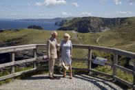 The Prince of Wales and the Duchess of Cornwall pose at the lookout point during a visit to Tintagel Castle while on a three day visit to Cornwall.