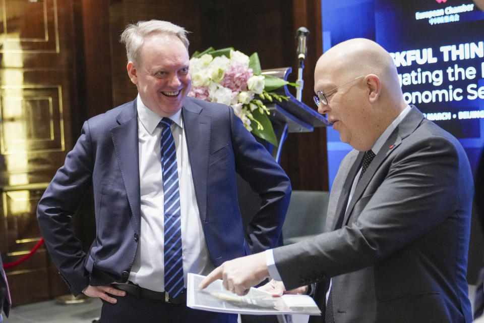 President of the European Union Chamber of Commerce in China Jens Eskelund, left, arrives before a press conference for European Chamber in Beijing, China, Wednesday, March 20, 2024. Uncertainty and “draconian regulations” have drastically raised risks for foreign businesses in China, a report by a European business group said Wednesday. (AP Photo/Tatan Syuflana)