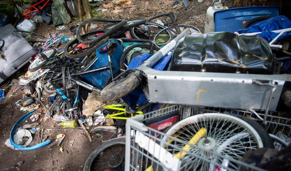 Hundreds of bicycle parts were strewn around a camp in Switchyard Park cleared by the city of Bloomington on Wednesday.