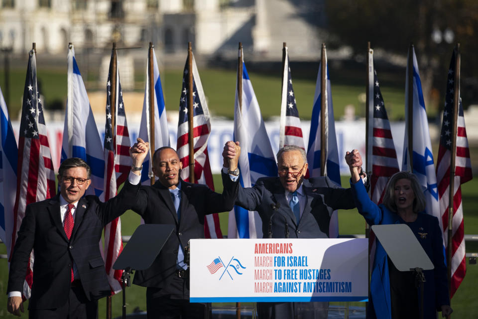 US House Speaker Mike Johnson, a Republican from Louisiana, from left, Representative Hakeem Jeffries, a Democrat from New York, Senate Majority Leader Chuck Schumer, a Democrat from New York, and Senator Joni Ernst, a Republican from Iowa, hold hands during a 