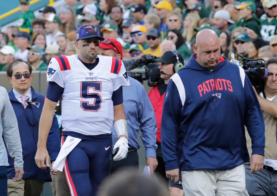 New England Patriots quarterback Brian Hoyer (5) leaves the field in the second quarter against the Green Bay Packers on Sunday, Oct. 2, at Lambeau Field in Green Bay, Wisconsin. He was being evaluated for a head injury.