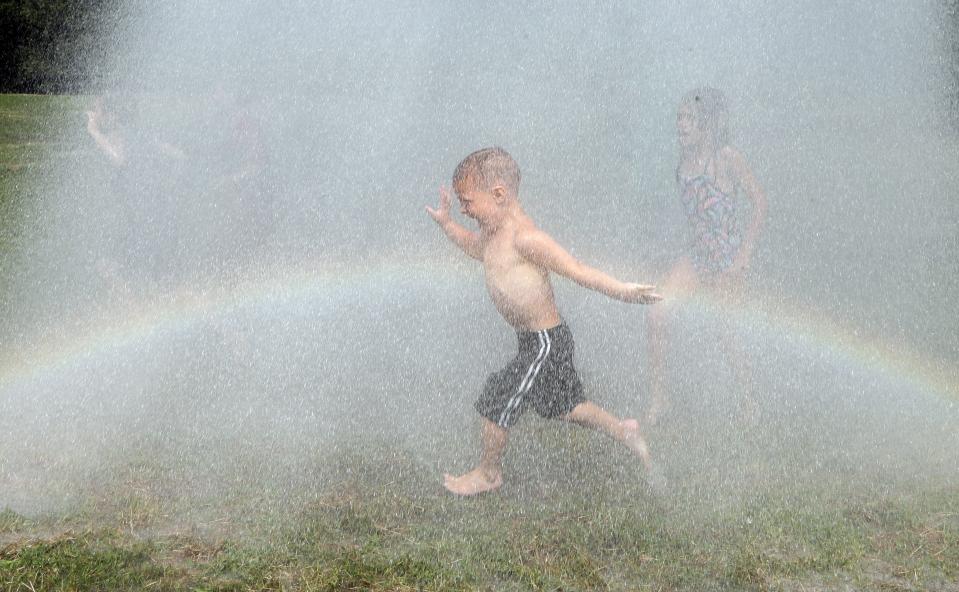 A child rinses himself off after participating in Mud Day at the Nankin Mills Park, Tuesday, July 9, 2019, in Westland, Mich. The annual day is for kids 12 years old and younger. While parents might be welcome, this isn't an event meant for teens or adults. It's all about the kids having some good, unclean fun during their summer break and is sponsored by the Wayne County Parks. (AP Photo/Carlos Osorio) (AP Photo/Carlos Osorio)