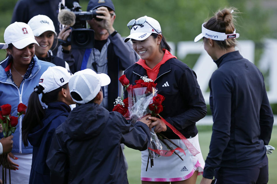 Rose Zhang, second from right, is given roses after winning the Mizuho Americas Open golf tournament on the second playoff hole, Sunday, June 4, 2023, in Jersey City, N.J. (AP Photo/Adam Hunger)
