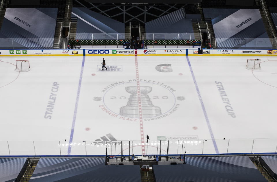 Ice crews work at the NHL playoffs venue in Edmonton, Alberta, Friday, Aug. 28, 2020. Boston Bruins captain Zdeno Chara hopes players and fans take a step back to pause and reflect on racial justice issues as the NHL takes a second day off from second-round series action on Friday, before games resume on Saturday. (Jason Franson/The Canadian Press via AP)