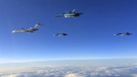 Russian military jets fly above an unidentified location after taking off from the country's air base in Hmeymin, Syria to head back to Russia, part of a partial withdrawal ordered by President Vladimir Putin, in this still image taken from video March 15, 2016. REUTERS/Russian Ministry of Defence via REUTERS TV