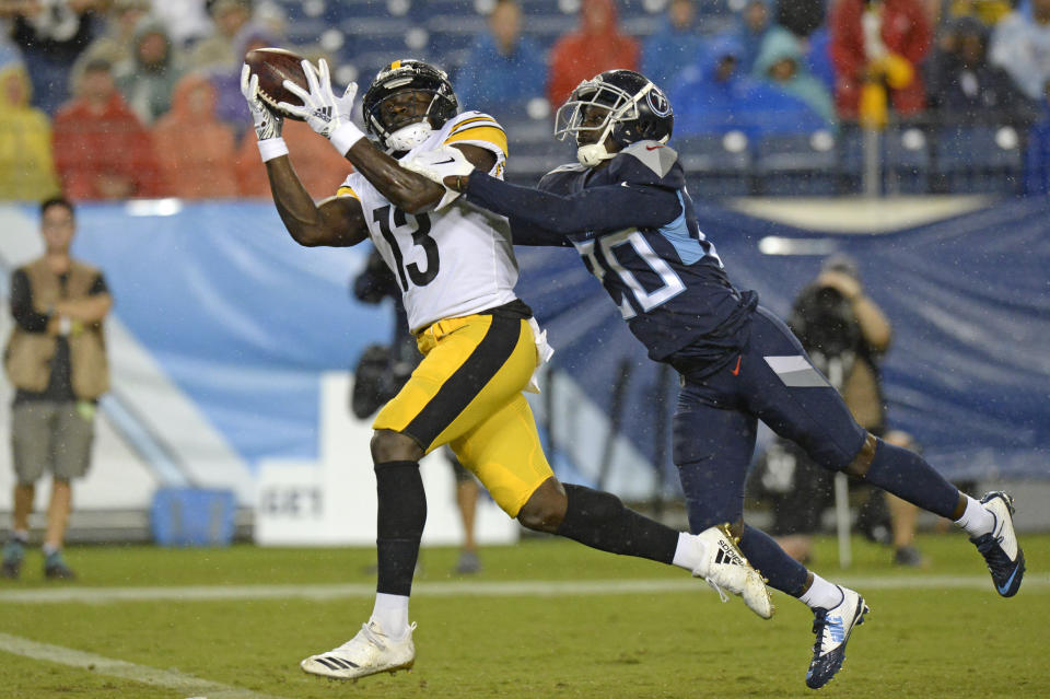 Pittsburgh Steelers wide receiver James Washington (13) catches a 41-yard touchdown as he is defended by Tennessee Titans defensive back Kenneth Durden (20) in the first half of a preseason NFL football game Sunday, Aug. 25, 2019, in Nashville, Tenn. (AP Photo/Mark Zaleski)