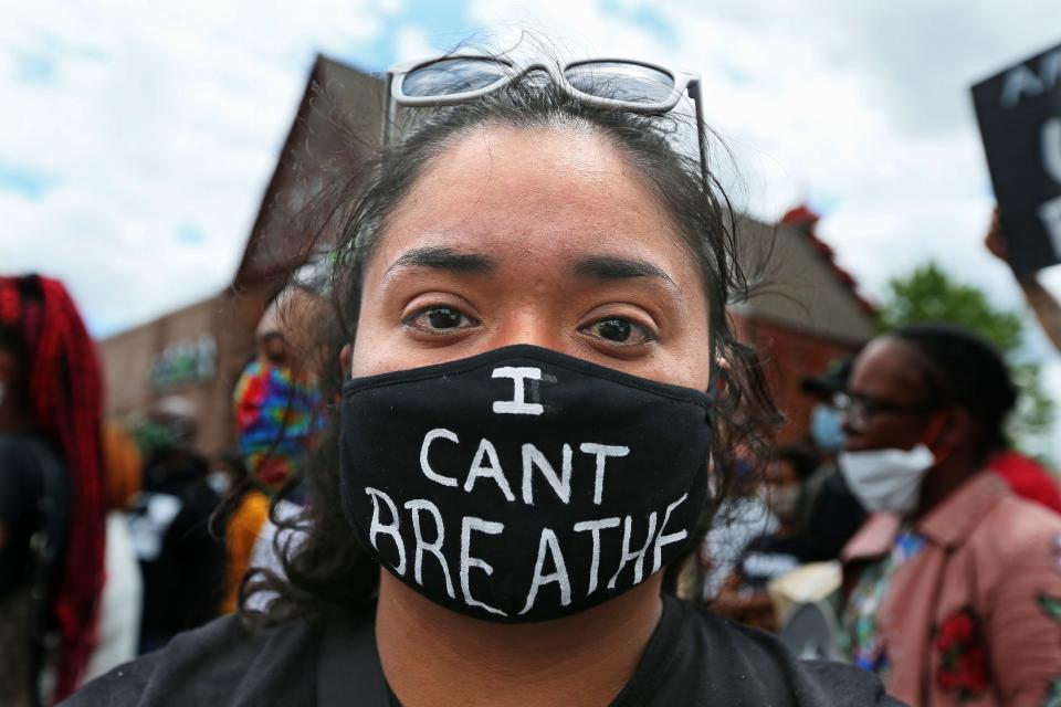 Alondra Garcia, a second-grade MPS teacher, wears a mask she made to remember George Floyd, who was killed by a Minneapolis police officer, during a protest at 26th and Center streets on Friday, May 29, 2020.