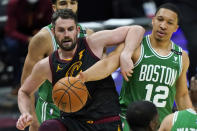 Cleveland Cavaliers' Kevin Love, left, and Boston Celtics' Grant Williams vie for the ball during the second half of an NBA basketball game Wednesday, May 12, 2021, in Cleveland. The Cavaliers won 102-94. (AP Photo/Tony Dejak)