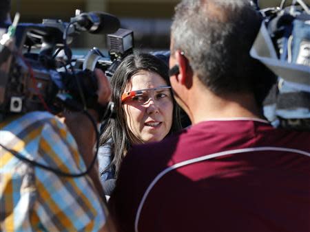 Defendant Cecilia Abadie is surrounded by news cameras as she arrives at a traffic court in San Diego January 16, 2014. REUTERS/Mike Blake