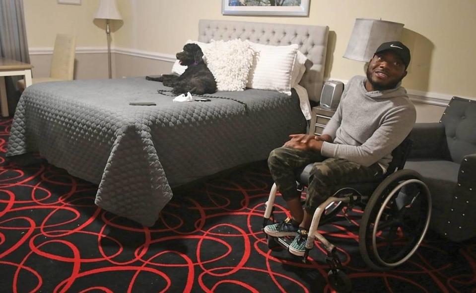 Keith Foster and his dog Tori in their new apartment at Independence Place.