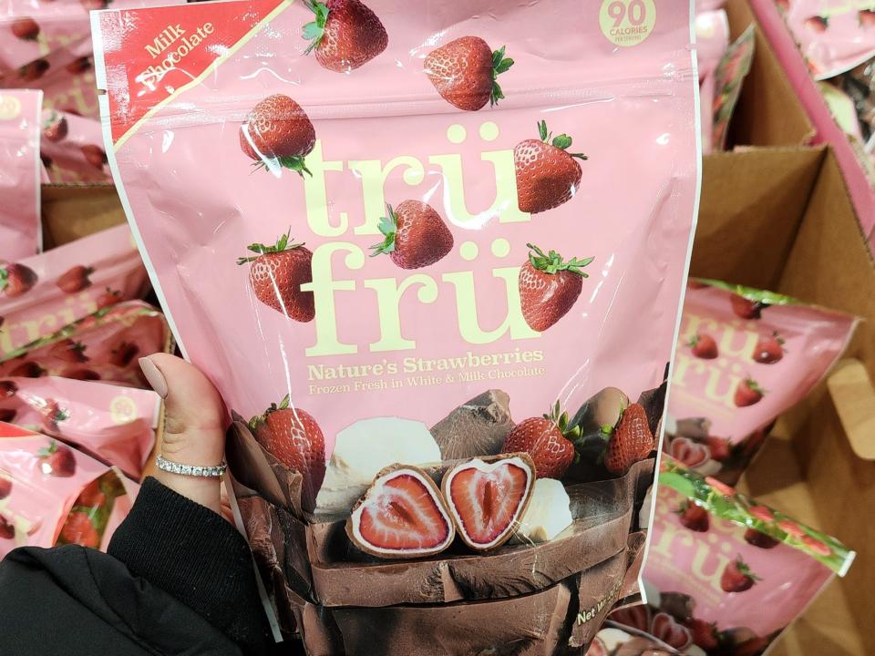 The writer holds a pack of Tru Fru strawberries