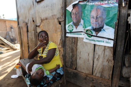 A woman points to election posters for President John Mahama at Bosomtwe Sam fishing harbour, Sekondi on Saturday. Mahama says the idea of free secondary education in Ghana is great on paper, but not yet possible as the money shortage could greatly harm education in this nation of 20 million people