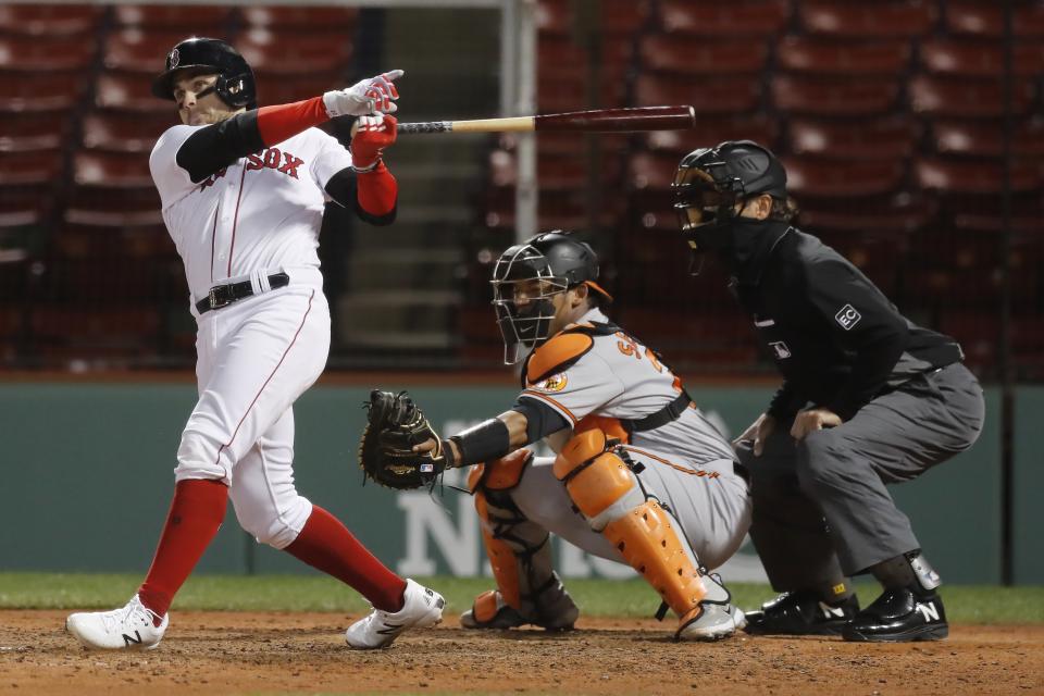 Boston Red Sox's Michael Chavis grounds into a double play with the bases loaded, in front of Baltimore Orioles catcher Pedro Severino during the fifth inning of a baseball game Tuesday, Sept. 22, 2020, in Boston. (AP Photo/Michael Dwyer)