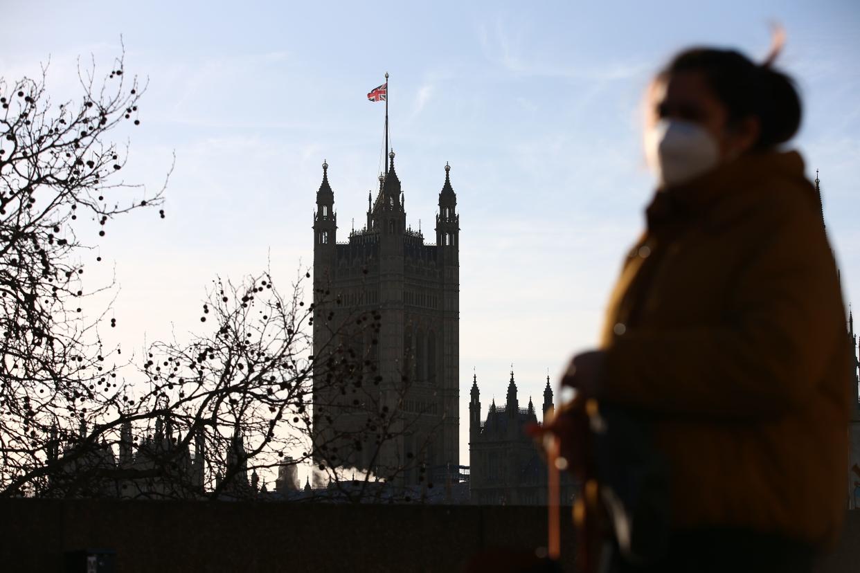 A pedestrian walks in central London with the Houses of Parliament in the background as data shows falling trust in government. Photo: Hollie Adams/AFP via Getty