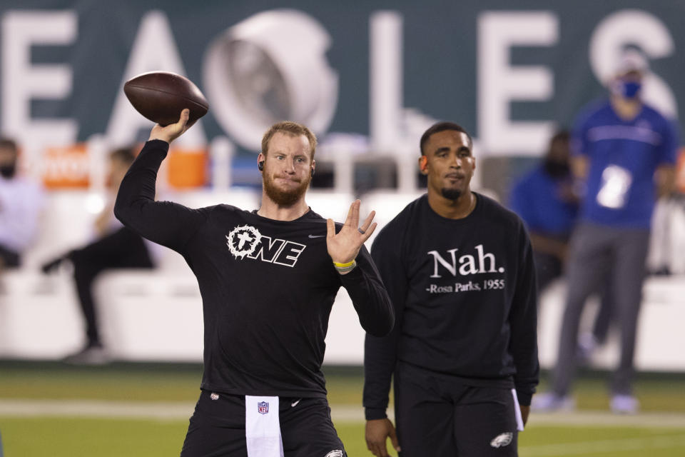 Carson Wentz, left, or Jalen Hurts, right? The Philadelphia Eagles have a QB situation they need to figure out. (Photo by Mitchell Leff/Getty Images)
