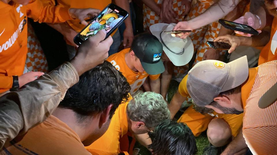 Ned Vickers, middle without hat, works to saw a field-goal post from Neyland Stadium after Tennessee beat Alabama on Oct. 15, 2022.