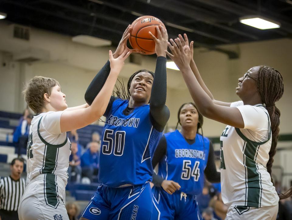 Georgetown center Cassady Lee battles for possession of an offensive rebound against McNeil. The Eagles have won three games over District 25-6A opponents.