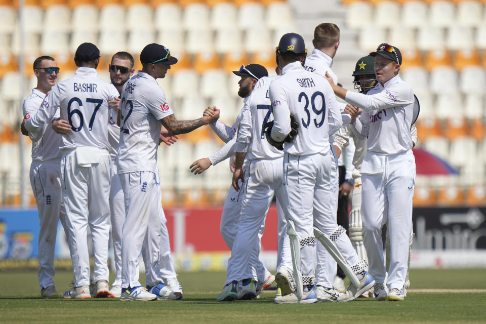 England's Ollie Pope, right, and teammates are congratulated each others after winning the first test cricket match against Pakistan, in Multan, Pakistan, Friday, Oct. 11, 2024. (AP Photo/Anjum Naveed)