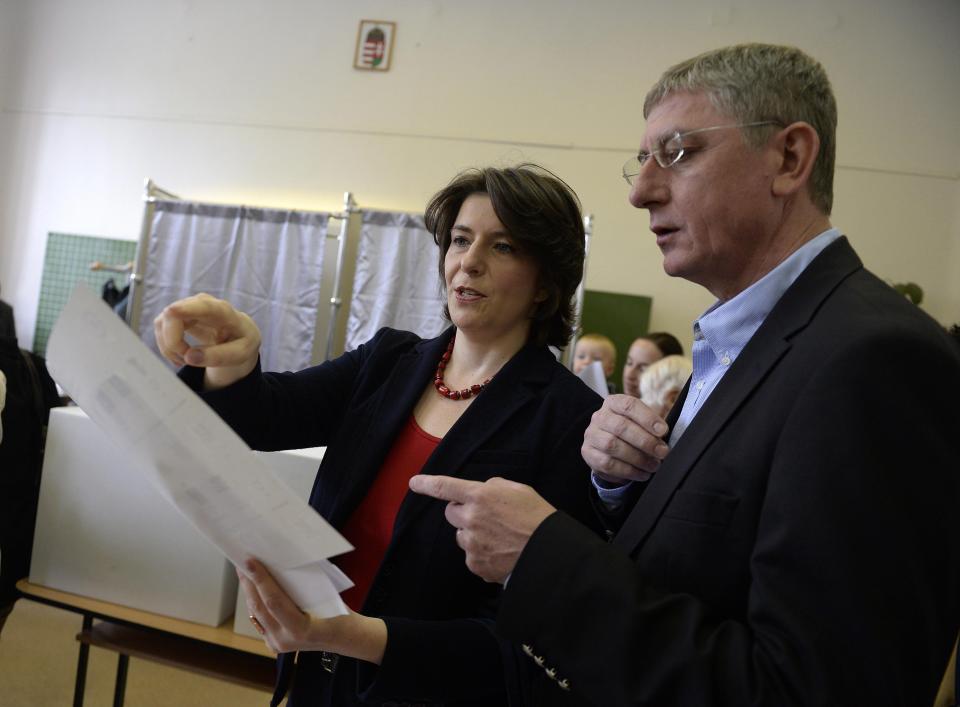 Leader of Democratic Coalition, former Prime Minister Ferenc Gyurcsany and his wife Klara Dobrev watch the ballot papers at a polling station in Budapest during the parliamentary elections in Hungary, Sunday, April 6, 2014. Hungary's governing party is tipped to win parliamentary elections Sunday, while a far-right party is expected to make further gains, according to polls. Prime Minister Viktor Orban's Fidesz party and its small ally, the Christian Democrats, are expected to win easily and they may even retain the two-thirds majority in the legislature gained in 2010 which allowed them to pass a new constitution, adopt unconventional economic policies, centralize power and grow the state's influence at the expense of the private sector. (AP Photo/MTI,Noemi Bruzak)