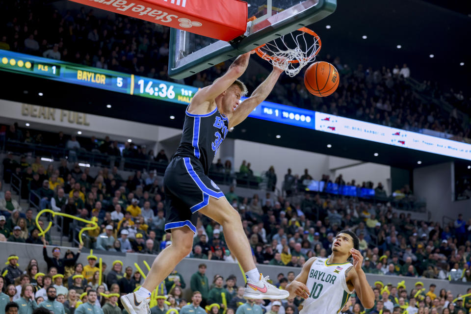 BYU guard Dallin Hall (30) dunks as Baylor guard RayJ Dennis (10) watches during the first half of an NCAA college basketball game Tuesday, Jan. 9, 2024, in Waco, Texas. (AP Photo/Gareth Patterson)