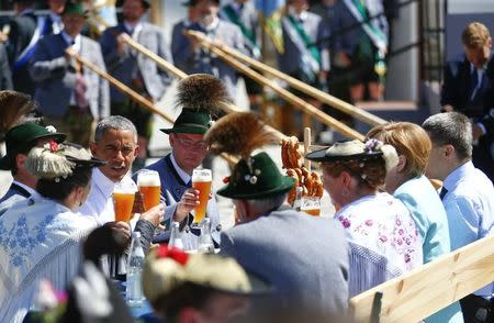 U.S. President Barack Obama (L) speaks as he sits at a table with German Chancellor Angela Merkel (2R) and her husband Joachim Sauer (R) in Kruen, southern Germany, June 7, 2015. REUTERS/Hannibal Hanschke