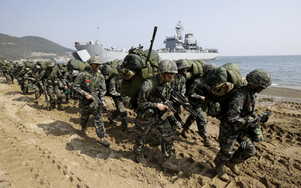 FILE - In this March 30, 2015, file photo, South Korean Marines march after landing on the beach during the U.S.-South Korea joint landing military exercises as a part of the annual joint military exercise Foal Eagle between South Korea and the United States in Pohang, South Korea. South Korea and the U.S. say they've decided to end their springtime military drills to back diplomacy with North Korea. (AP Photo/Lee Jin-man, File)