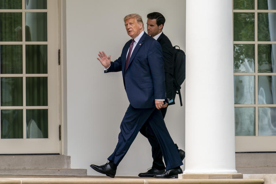 President Donald Trump, center, and director of the Presidential Personnel Office John McEntee, right, walk towards the Oval Office of the White House in Washington, Friday, Sept. 11, 2020, after returning from the Flight 93 National Memorial in Shanksville, Pa. (AP Photo/Andrew Harnik)