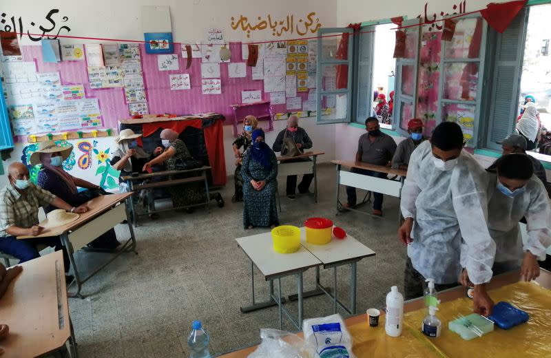 People wait to receive the COVID-19 vaccine in Jendouba