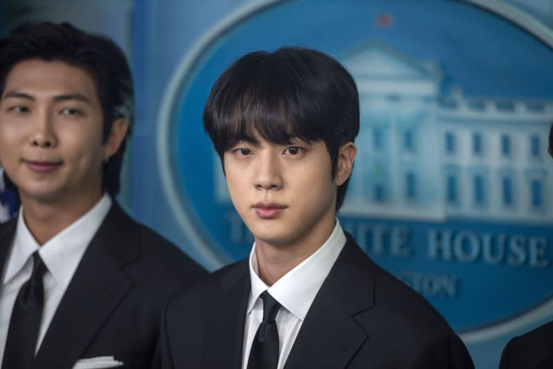 Jin (R), a member of the Korean Pop band BTS, looks on during the daily press briefing at the White House in Washington, D.C., on May 31, 2022. The K-pop singer, known as Jin, turns 31 on December 4. File Photo by Bonnie Cash/UPI