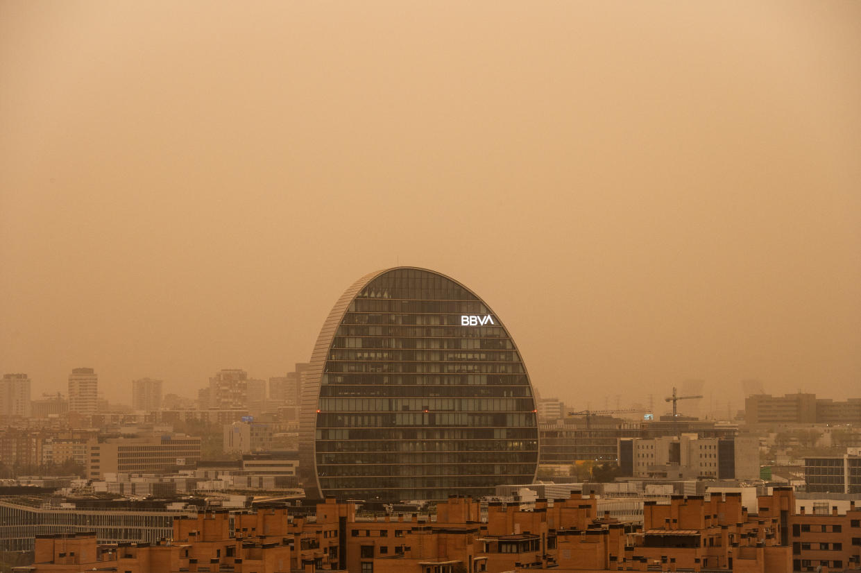 MADRID, SPAIN - 2022/03/15: BBVA bank headquarters is seen with mist generated by a high amount of dust particles in suspension coming from the Sahara, causing a decrease in air quality, sand in the streets, a reddish sky and rising temperatures. The Community of Madrid has advised to limit outdoor activities due to the bad air quality. (Photo by Marcos del Mazo/LightRocket via Getty Images)
