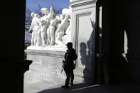 A Capitol police officer stands at the front entrance of the Pennsylvania Capitol building Tuesday Jan. 12, 2021, in Harrisburg, Pa. State capitols across the country are under heightened security after the siege of the U.S. Capitol last week. (AP Photo/Jacqueline Larma)